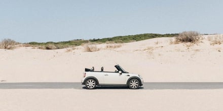 A car standing on sand at the beach