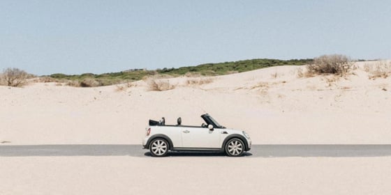 A car standing on sand at the beach