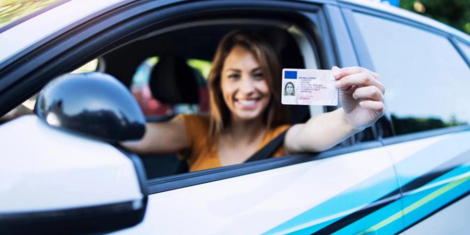 German woman holding her driving licence